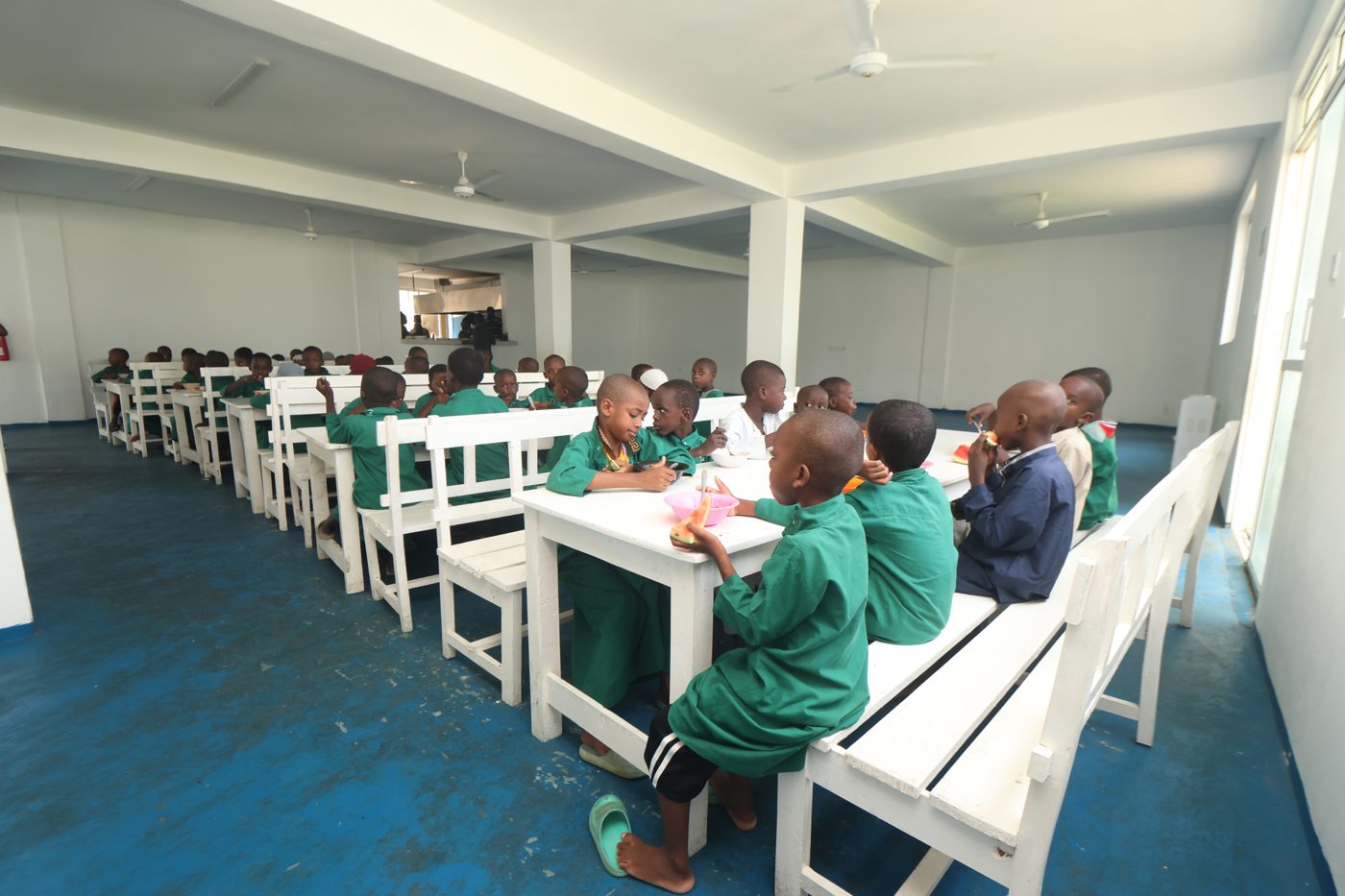 Boys sharing a meal in the Al-Falah dining hall